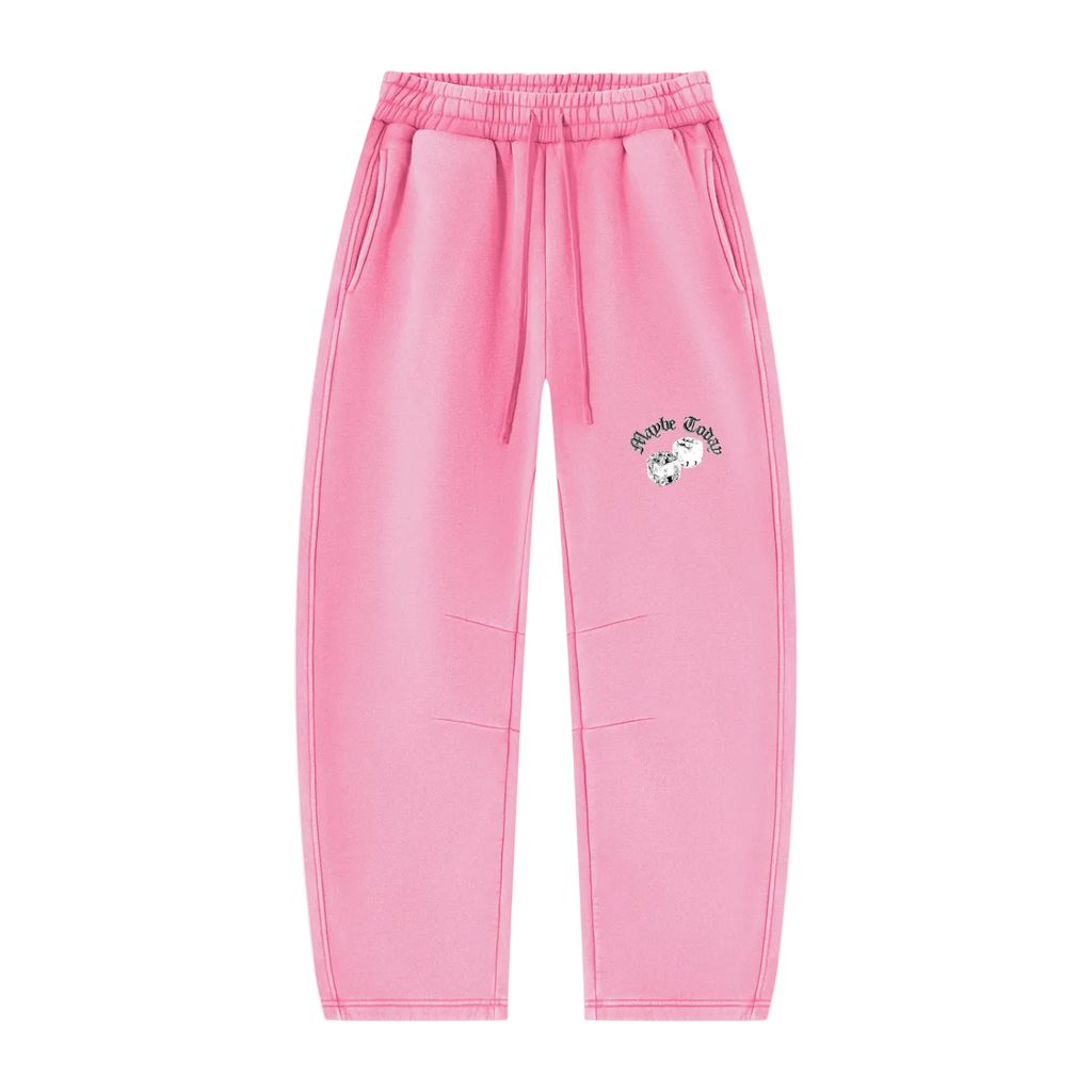 Pink sweatpants with an elastic waistband, drawstring, side pockets, and a small Hello Kitty graphic on the left thigh, shown against a plain white background.