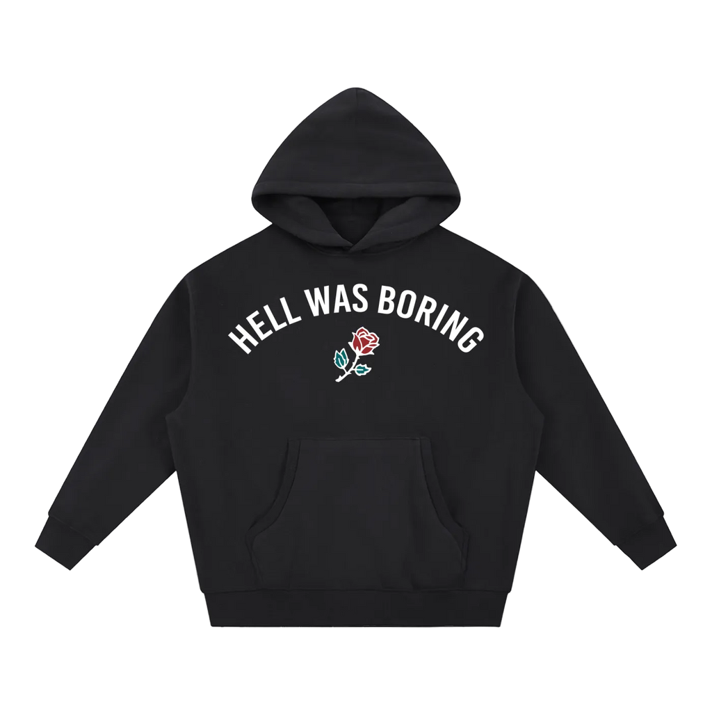 A black pullover hoodie with the phrase 'HELL WAS BORING' printed in white arched text across the chest, accompanied by a small embroidered rose graphic in red, green, and white. The hoodie is displayed flat against a solid white background.