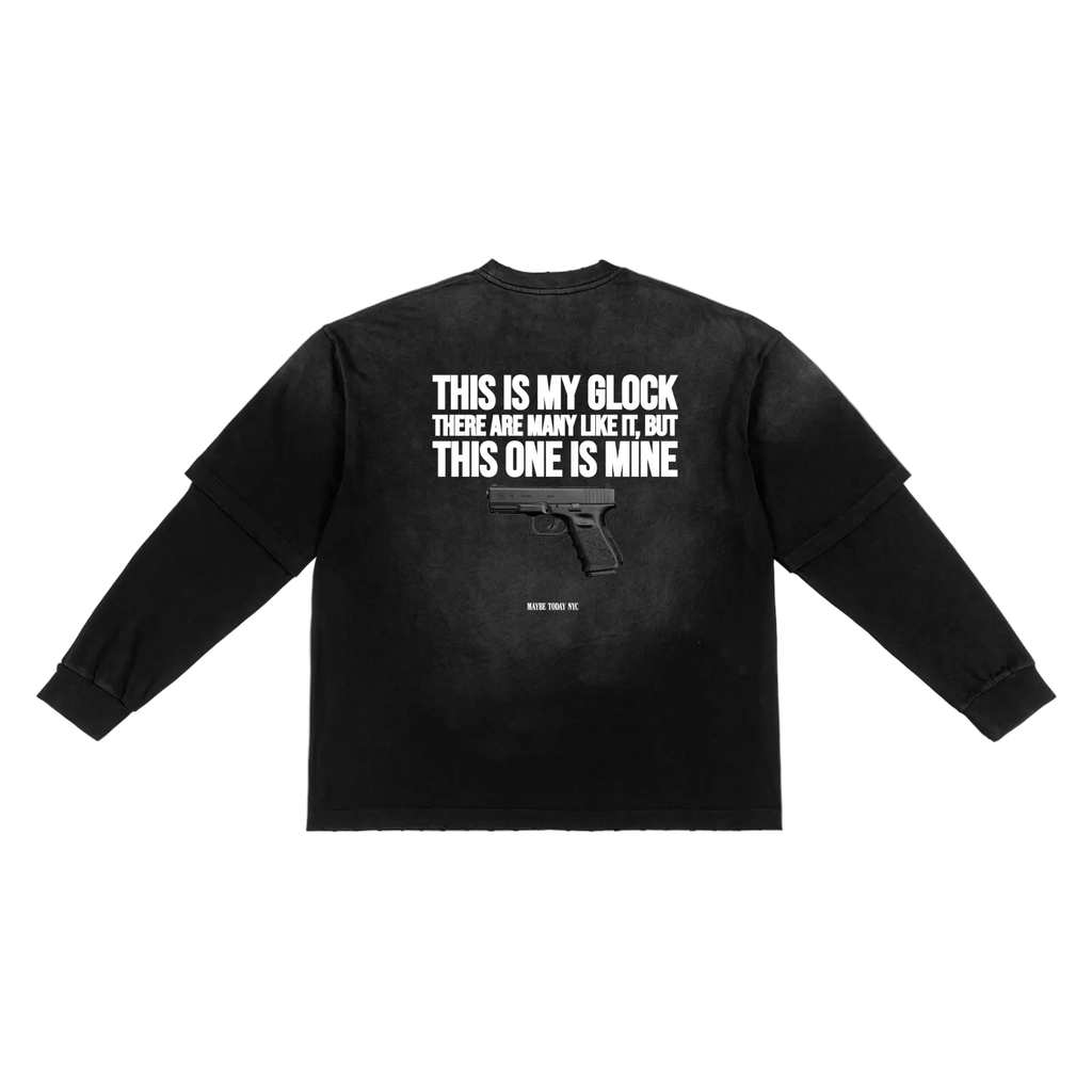 A black long-sleeve t-shirt with a white graphic print on the back featuring the text 'THIS IS MY GLOCK THERE ARE MANY LIKE IT BUT THIS ONE IS MINE' and a handgun silhouette, displayed flat against a white background.